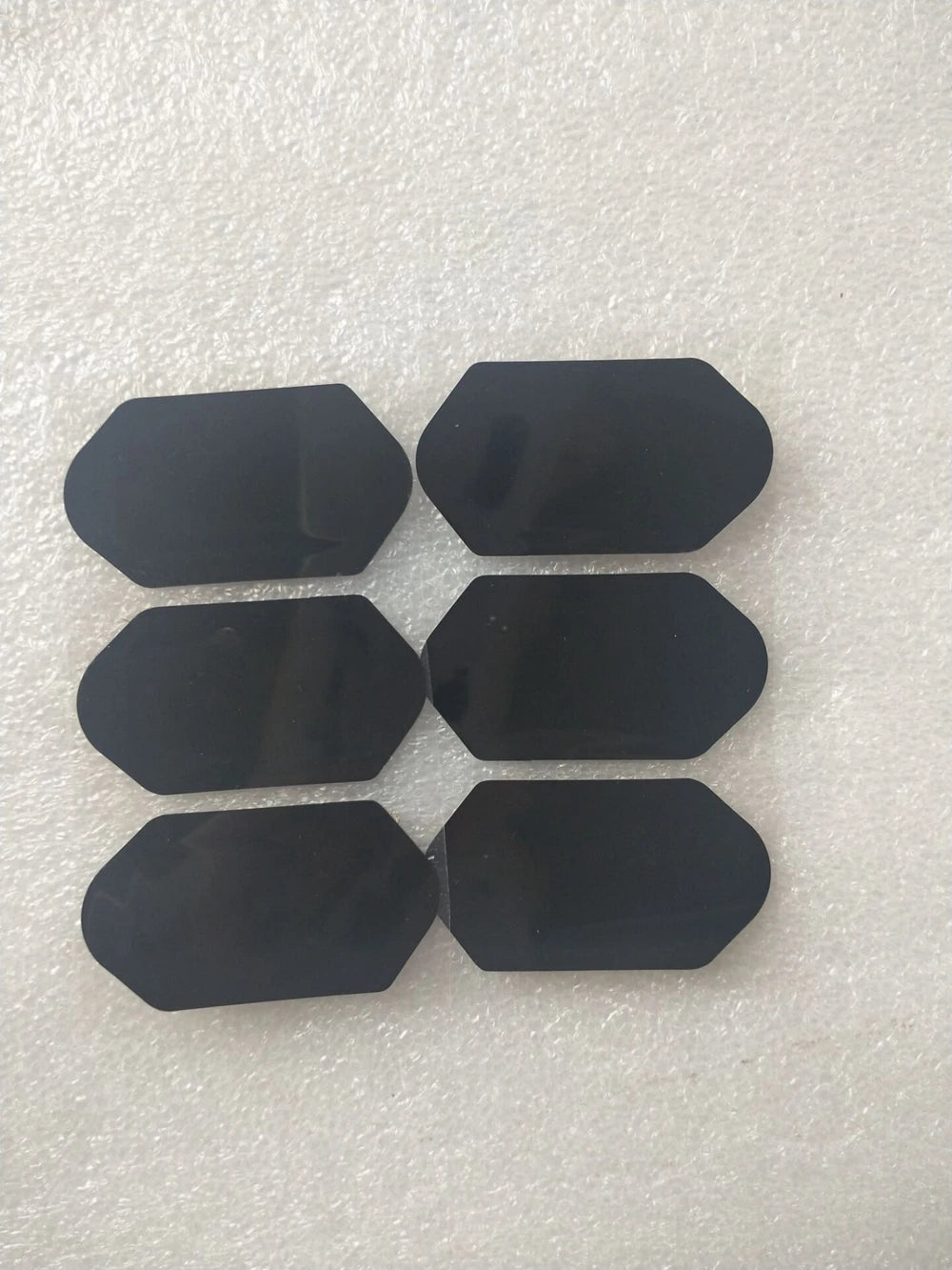 Set of six black replacement film stickers for 3D 4D HIFU machine cartridges, hexagon-shaped adhesive patches.