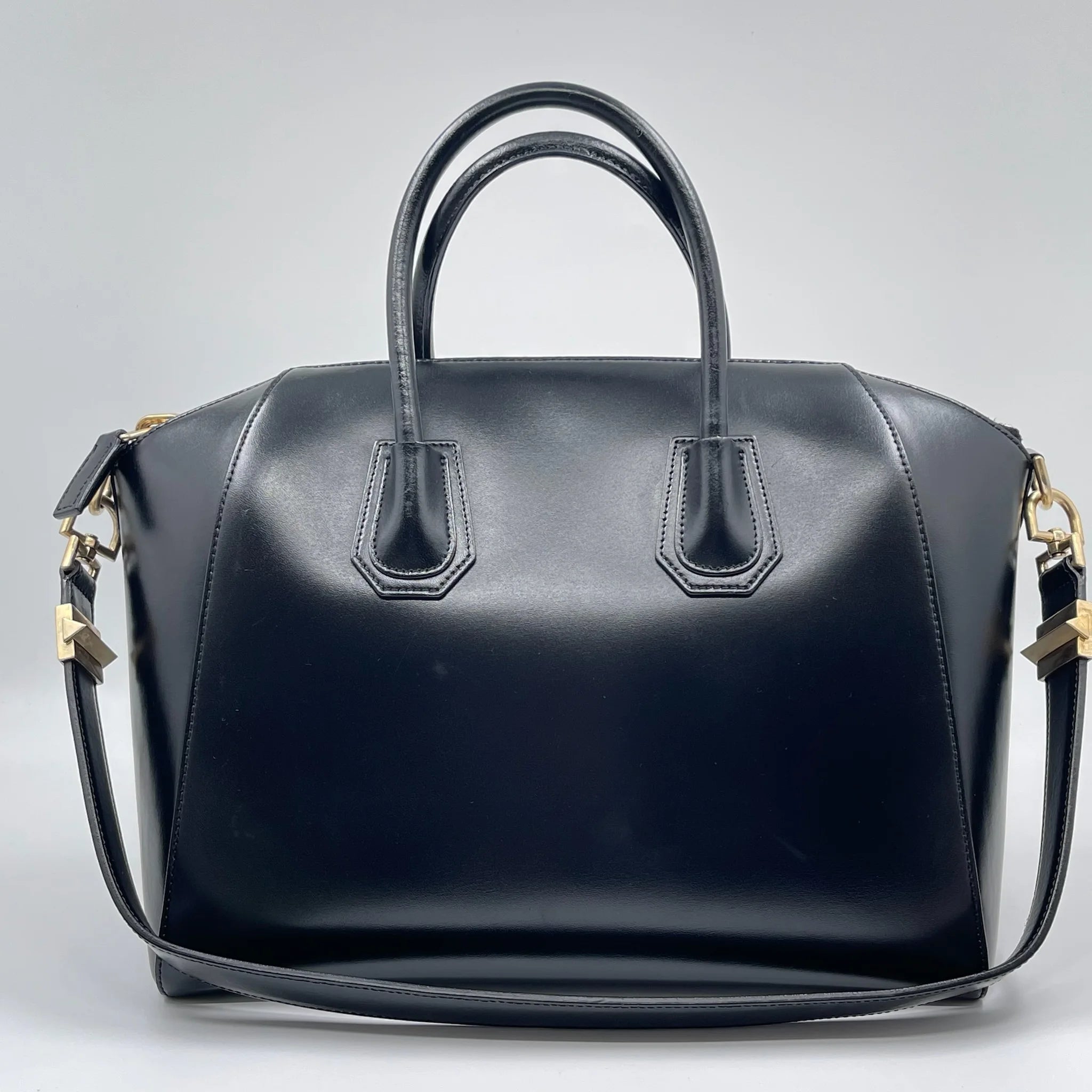 Luxury pre-owned black leather designer handbag, tote and crossbody style with gold hardware.