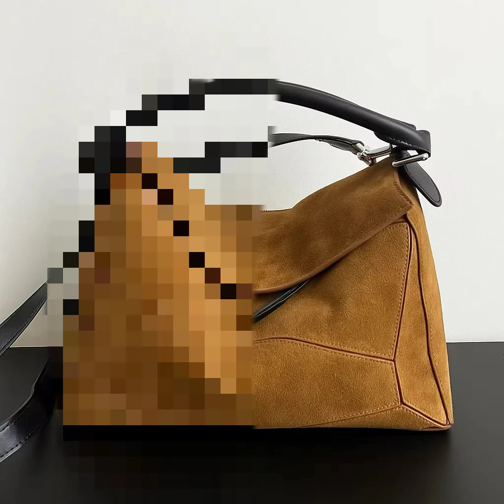 Tan suede designer handbag with structural paneling, black leather handle, and crossbody strap. Luxury 2025 style.