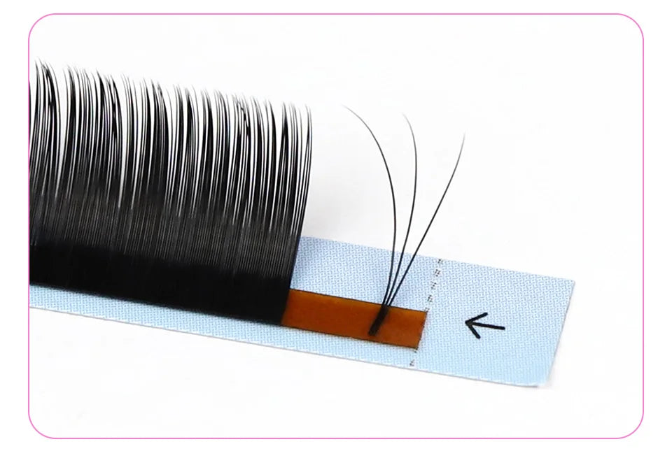 Black Tidesmit 0.03mm Russian volume eyelash extension fan on a light blue adhesive strip.
