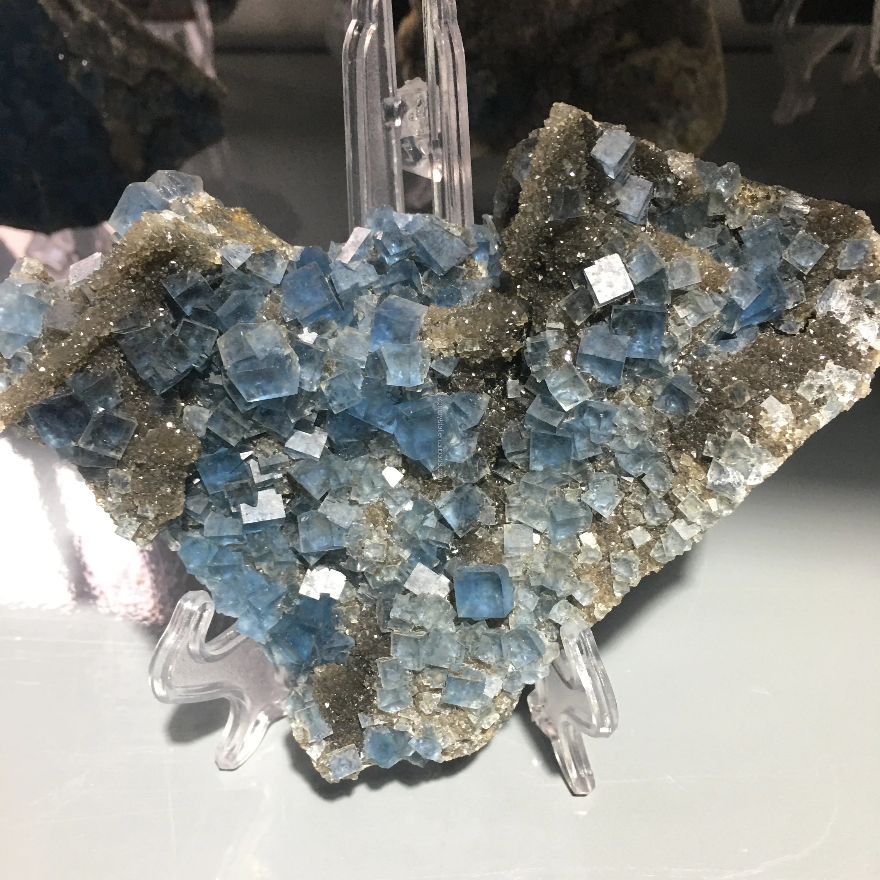Blue fluorite crystal cluster specimen with sparkly cubed crystals on stand