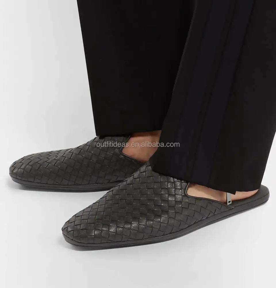 Dark brown woven leather mules with metal side detail and slim flat sole, luxury slip-on loafer style.