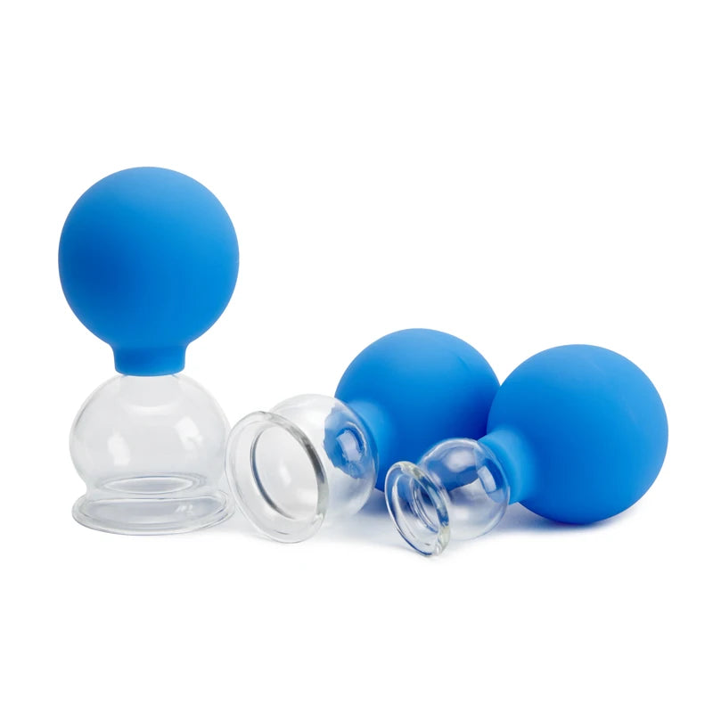 Three clear glass massage cupping jars with removable, round blue silicone suction bulbs on a white background.