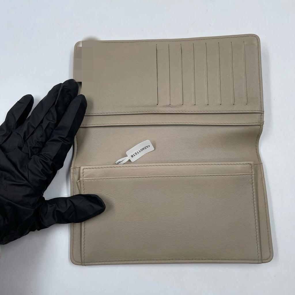 Pre-owned tan genuine leather designer wallet for women with internal card slots and elegant minimalist interior.
