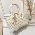 White designer shell handbag with gold geometric print, double handles, and metal zipper closure for daily use.