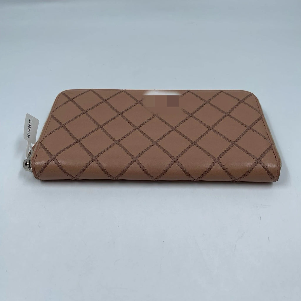 Tan quilted genuine leather zip-around clutch wallet, luxury designer handbag style for women.