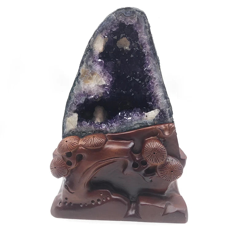 Purple amethyst geode decoration with a carved brown base and embossed floral designs