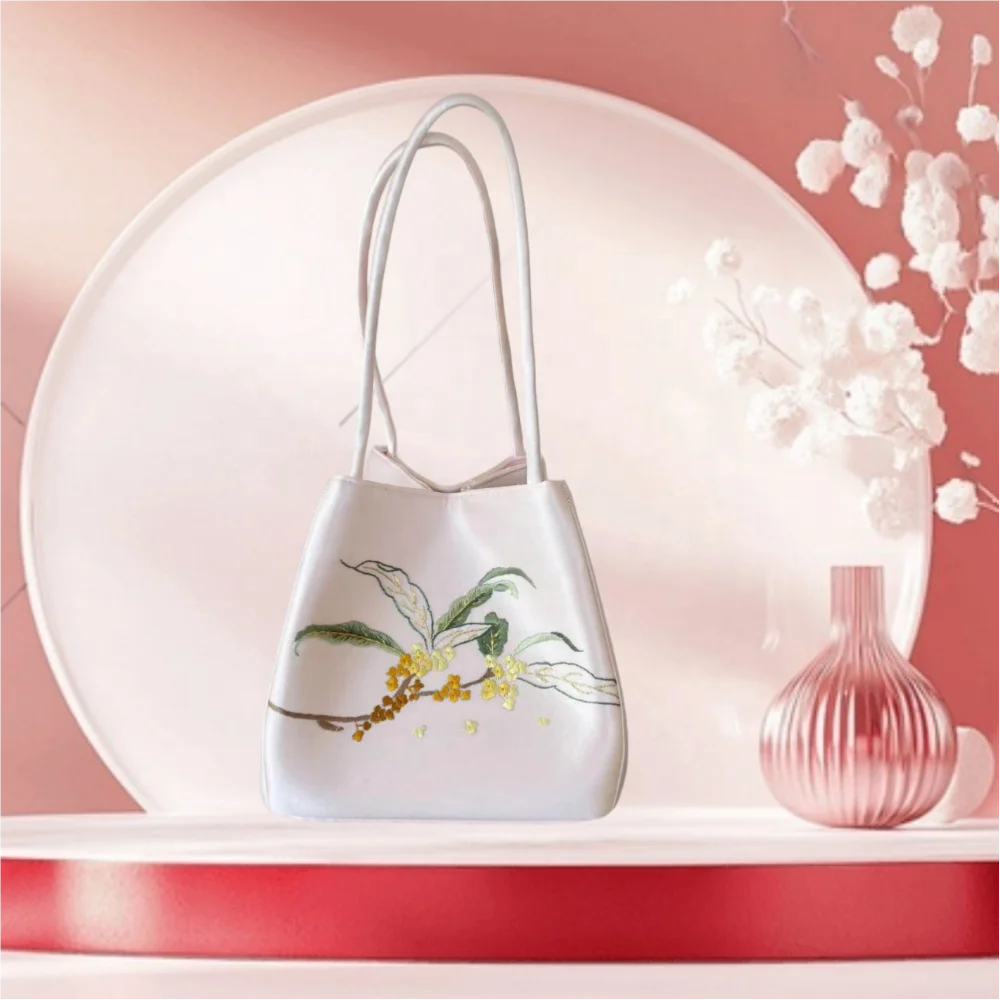 Lightweight white Suzhou embroidery crossbody purse featuring elegant yellow floral branch detail and dual carry handles.
