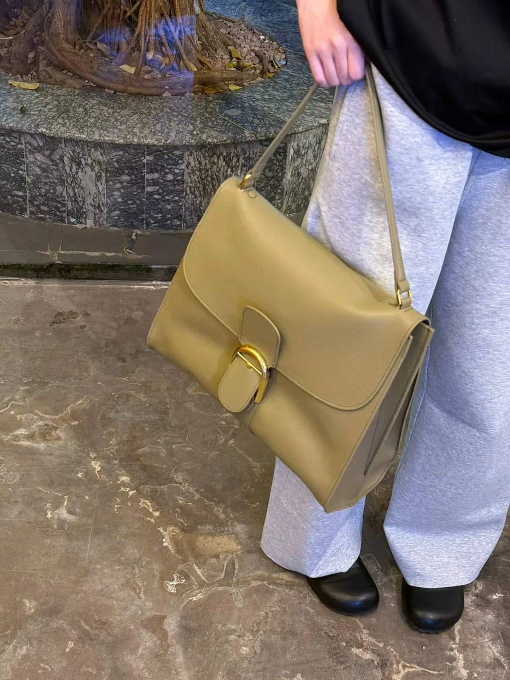 Olive green leather shoulder bag, designer tote with gold buckle closure and structured flap design.