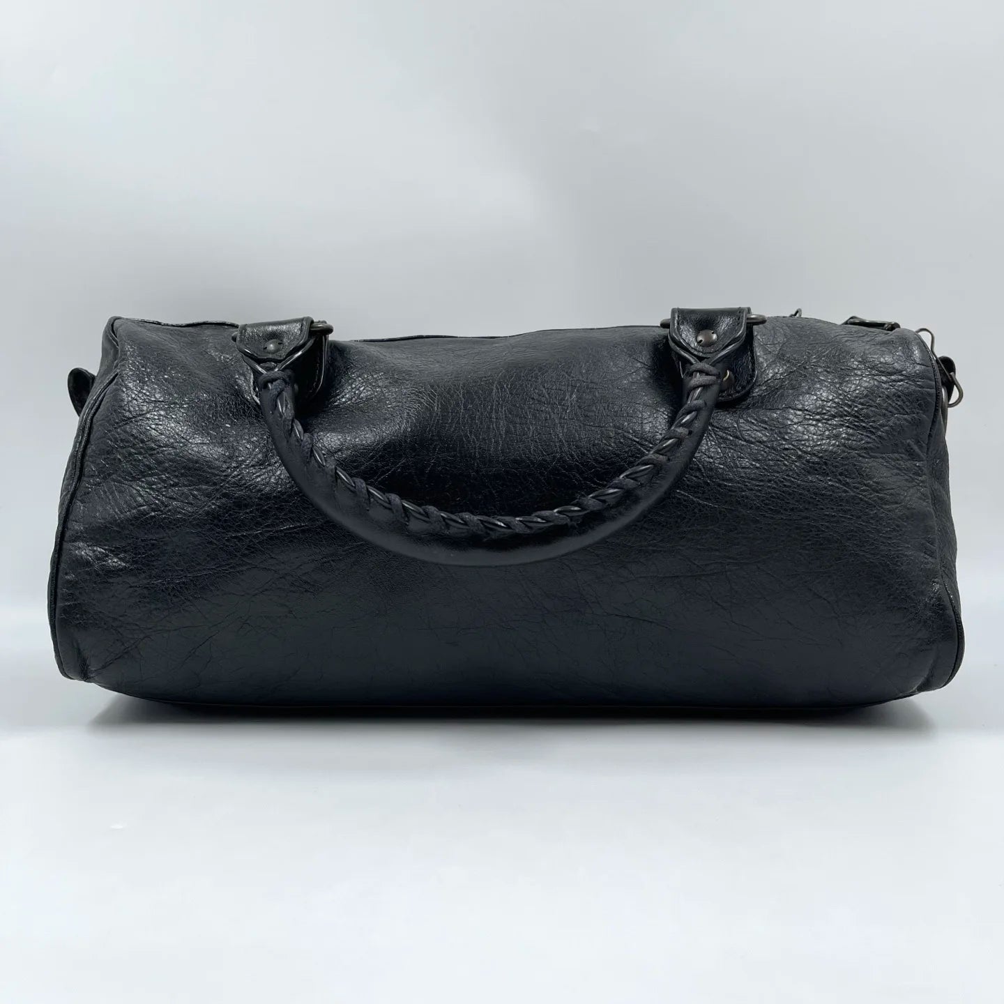 Black genuine leather pillow bag with braided handles, designer style, luxury second-hand tote.