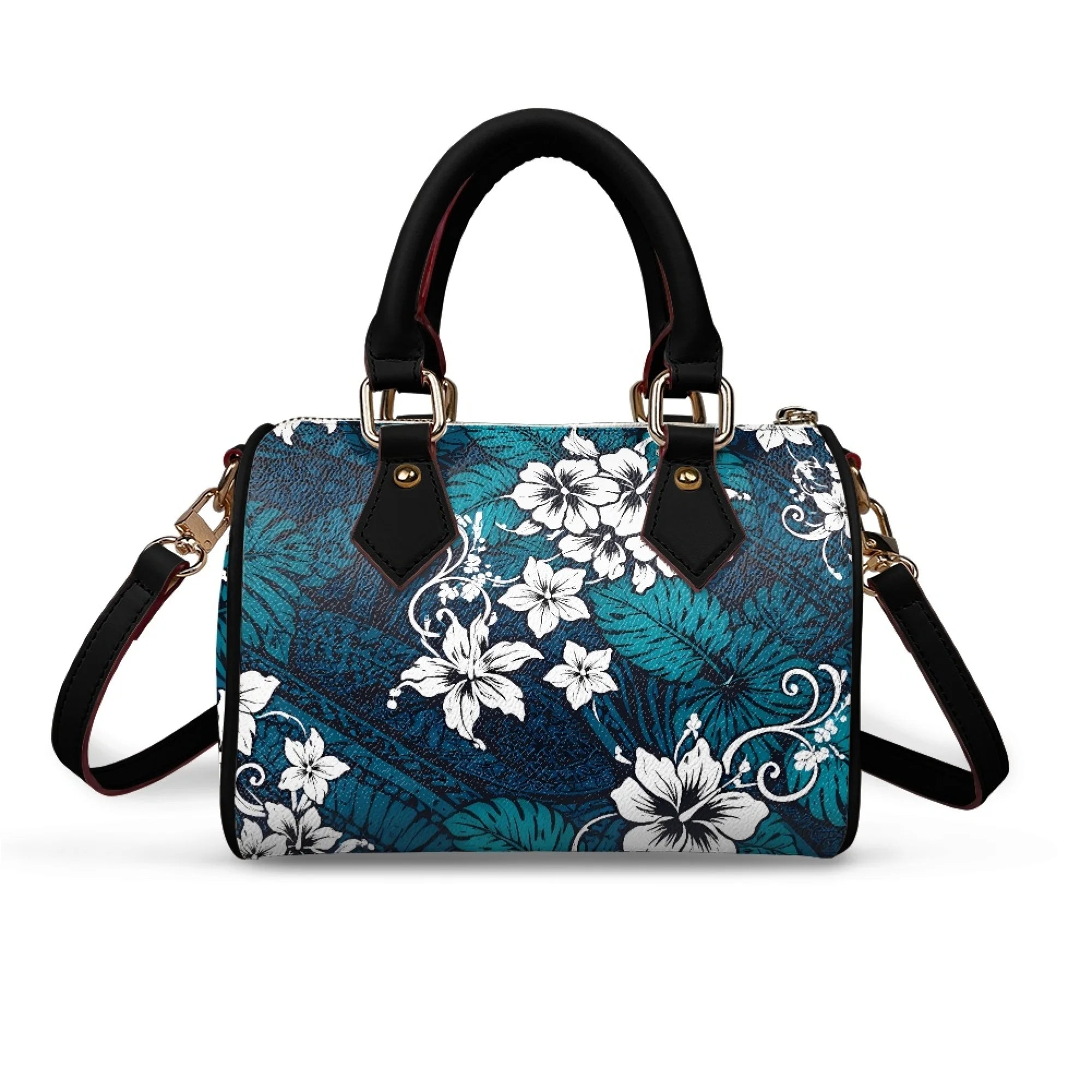 Pillow-shaped handbag in teal floral tribal print with black leather top handles, gold hardware, and shoulder strap.