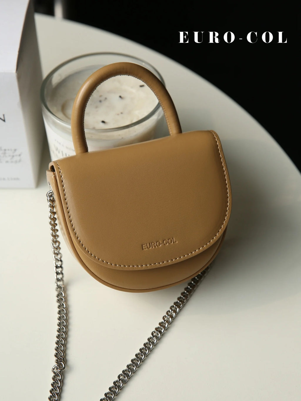 Tan cowhide leather mini top-handle clutch bag with silver chain strap, designer evening handbag for parties.