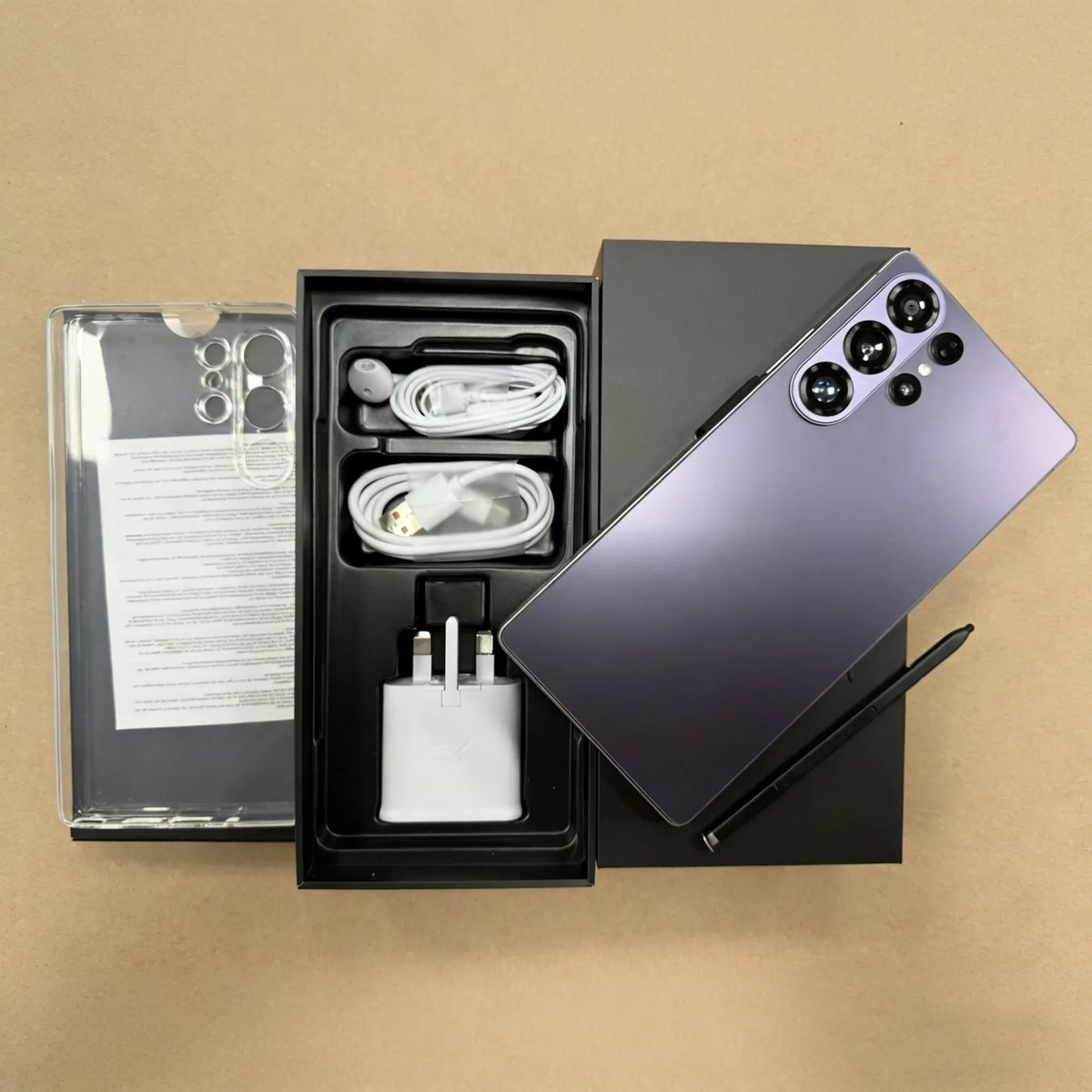 S26 Ultra smartphone with purple back, open box with cables and power adapter