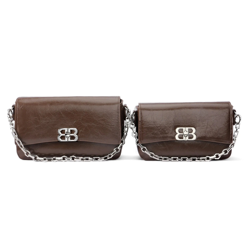 Dark brown genuine leather designer clutch bags with silver chain straps and metallic closure. Women’s shoulder bags.