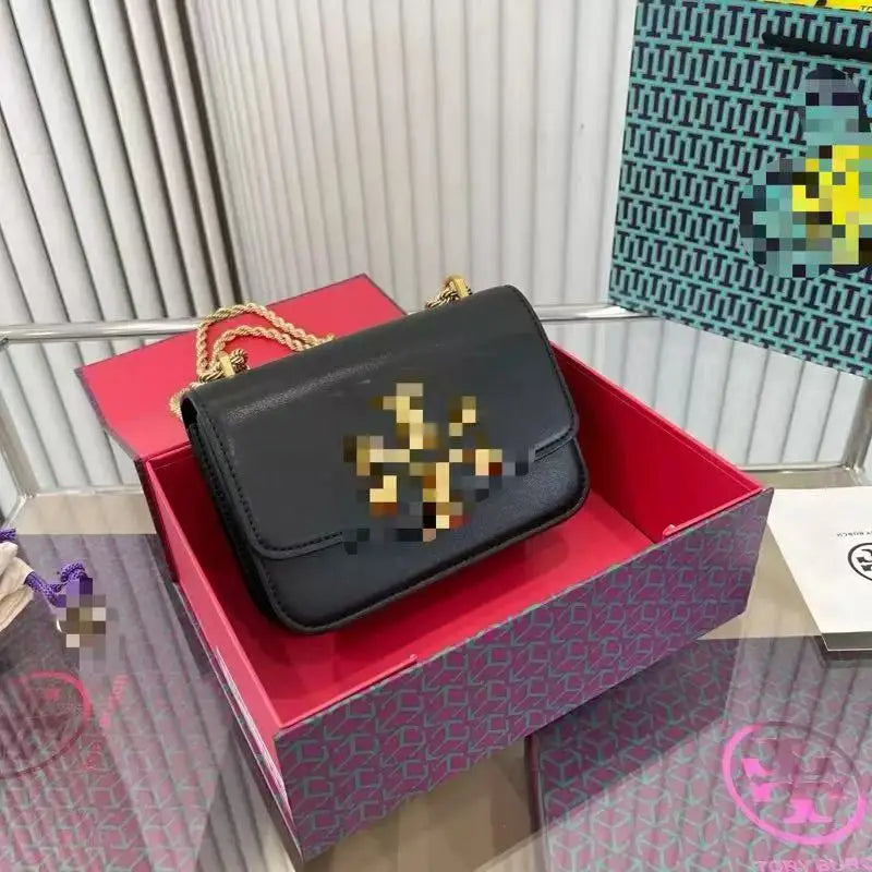 Black Zhenwo fashion trunk crossbody bag with gold metal hardware and chain strap in a branded gift box.