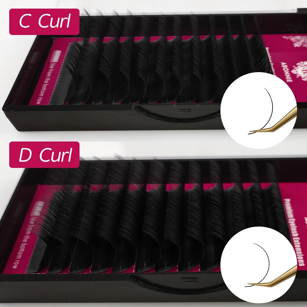 Black eyelash extension trays with C and D curl strips for professional cosmetic application.