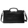 Black pebble PU leather designer handbag with a metallic oval top handle and detachable crossbody shoulder strap.
