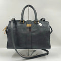 Black genuine leather luxury designer handbag, pillow shape with dual straps, gold hardware, and classic retro style.