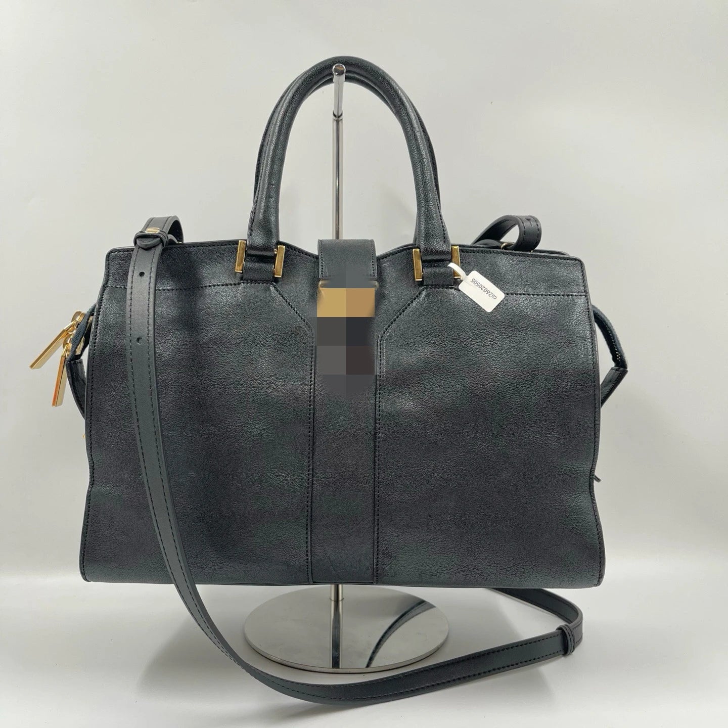 Black genuine leather luxury designer handbag, pillow shape with dual straps, gold hardware, and classic retro style.