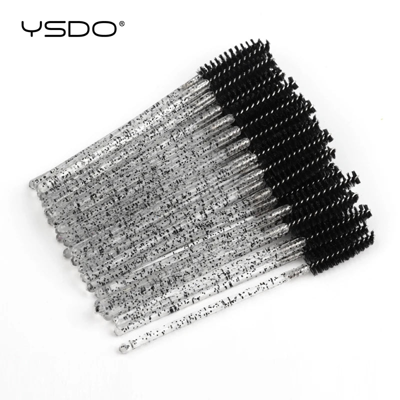 Disposable mascara wands with black bristles and clear glittery plastic handles for eyelash and eyebrow grooming.