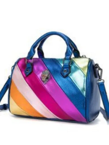 Metallic color-block trunk handbag with diagonal stripes, dual handles, detachable strap, and crystal eagle head emblem.