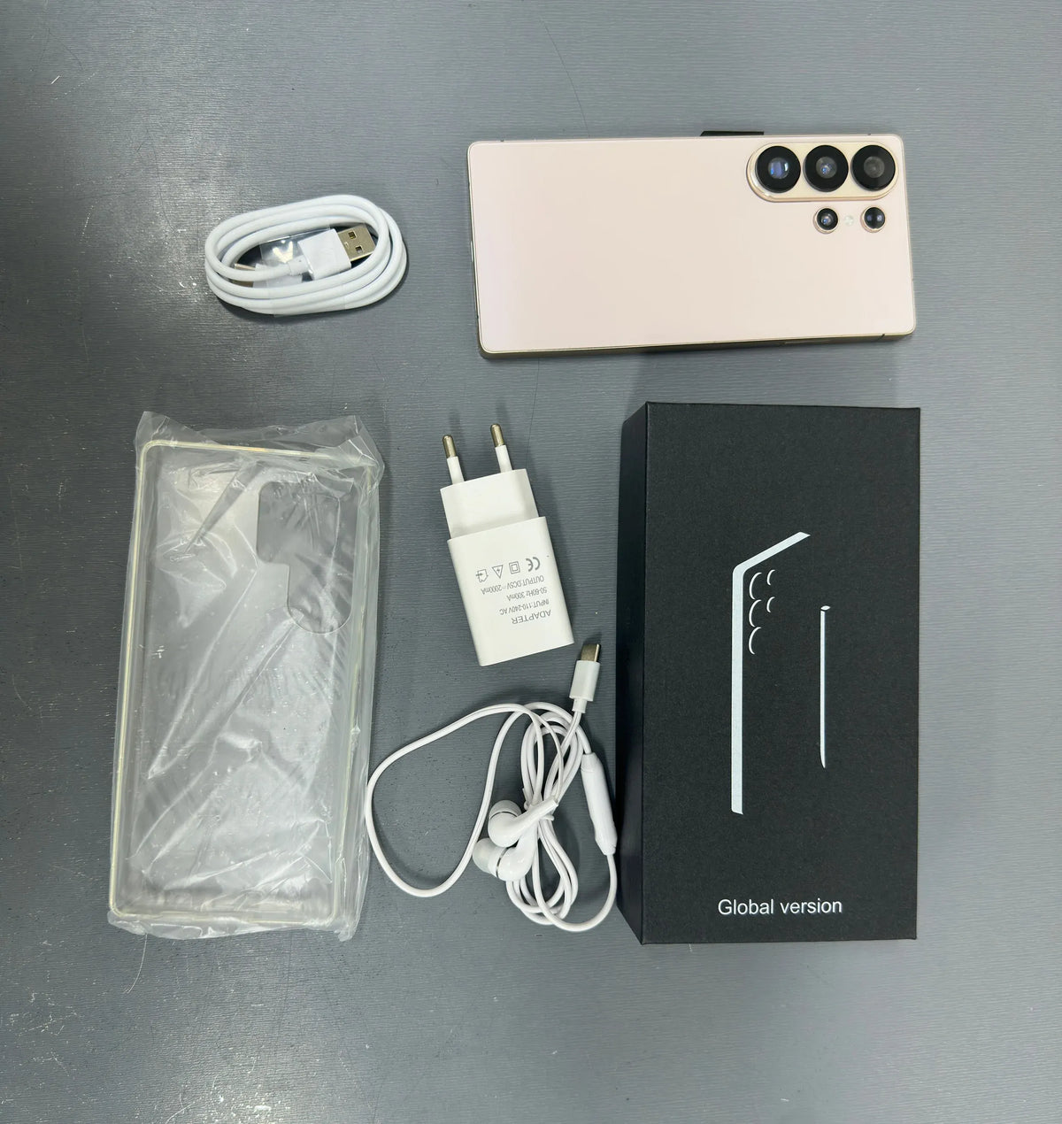 Smartphone with white back, charger, cable, and global version box with phone case