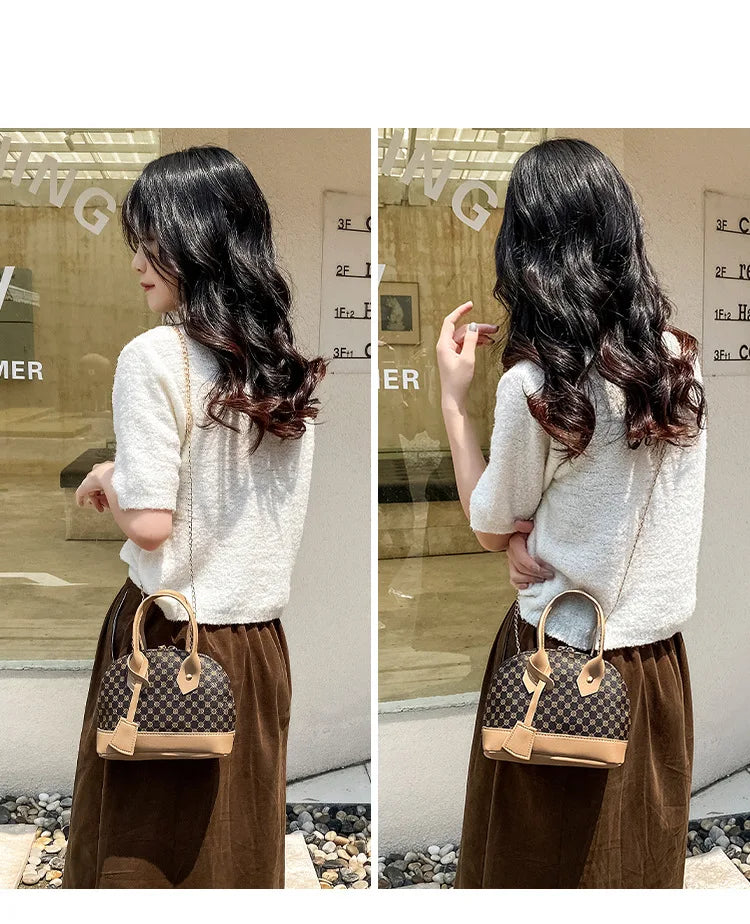 Brown patterned designer shell handbag with tan trim, top handles, and gold chain strap for daily fashion wear.