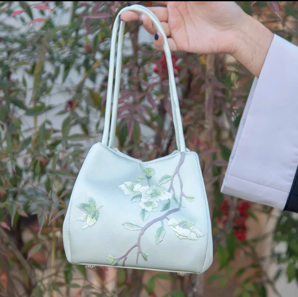 Classic light green satin handbag with delicate floral Su embroidery and twin handles for daily elegant style.