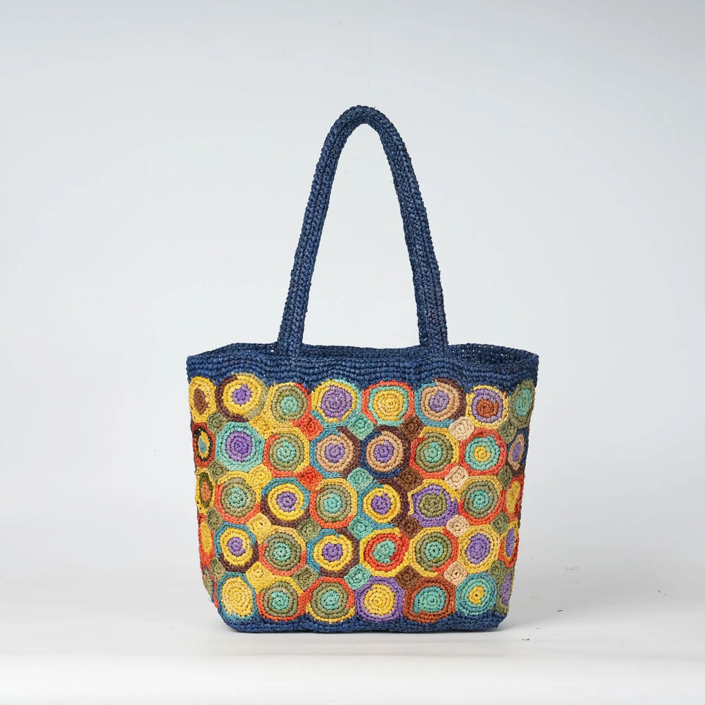 Blue woven crochet tote bag with multicolor spiral circular patterns, durable beach style ladies handbag.