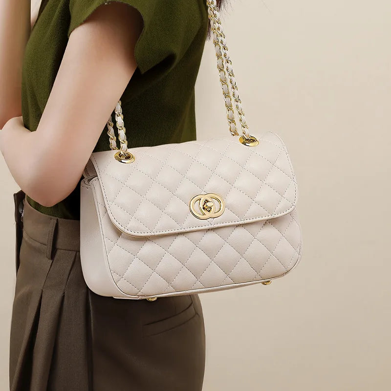 Off-white quilted genuine leather shoulder bag with gold turn-lock closure and chain strap, perfect as an evening purse.