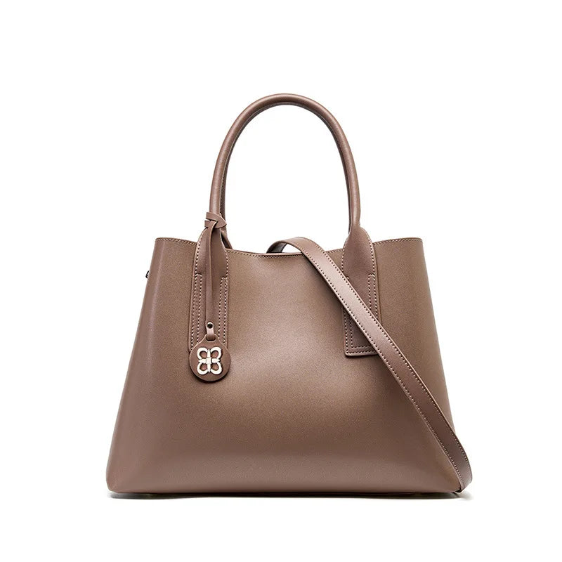 Taupe genuine leather designer handbag, large capacity tote with removable crossbody strap and silver clover charm.