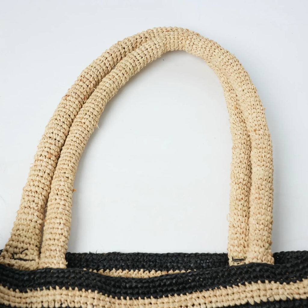 Beige and black striped crochet tote bag with woven handles, a lightweight fashion accessory for daily beach carry.