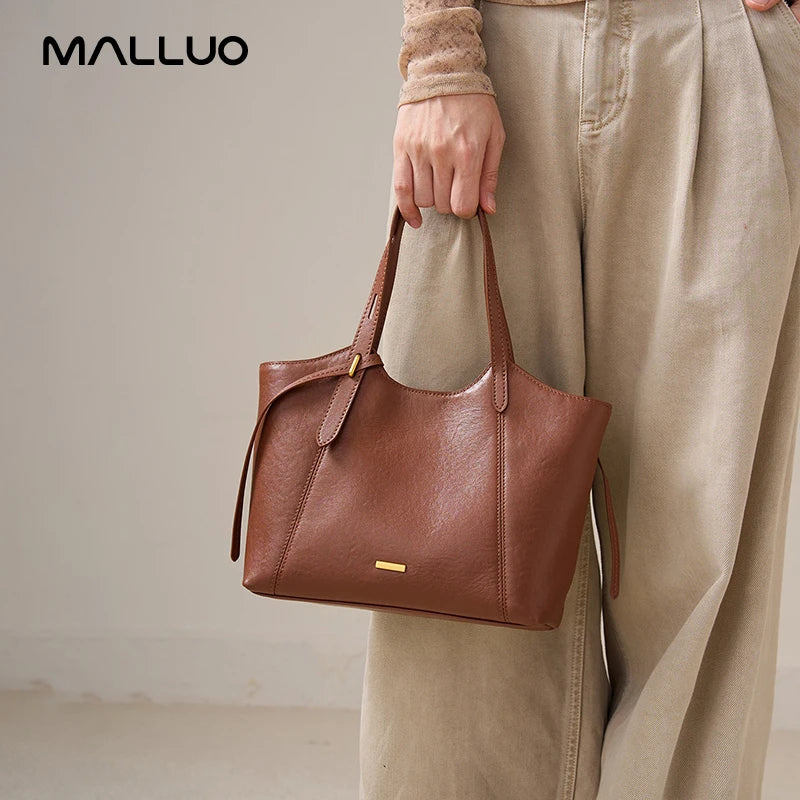 Brown genuine leather designer handbag, retro style, top-grain cowhide shoulder bag with gold hardware accents.