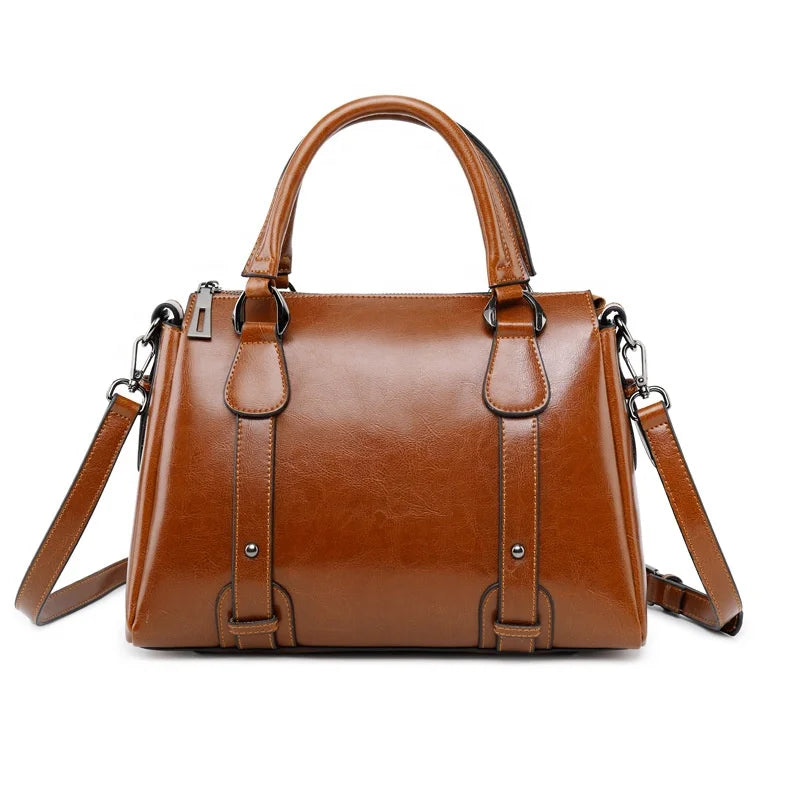 Tan genuine cow split leather designer handbag, top handle tote satchel with shoulder strap and metal accents.