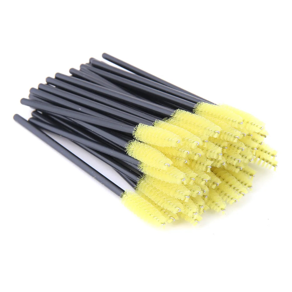 Disposable mascara wands with bright yellow nylon bristles and thin black plastic handles for eyelash application.