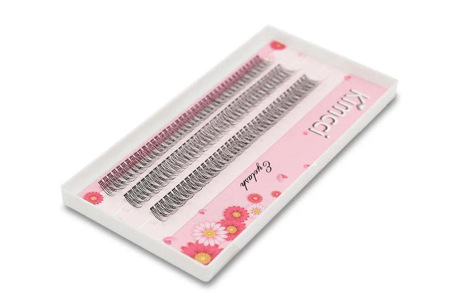 Tray of Kimcci black individual 3D mink cluster eyelash extensions with flared tips, in a white and floral pink box.