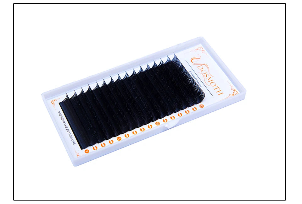 Black eyelash extension strips arranged in rows on a white plastic tray for professional beauty application.