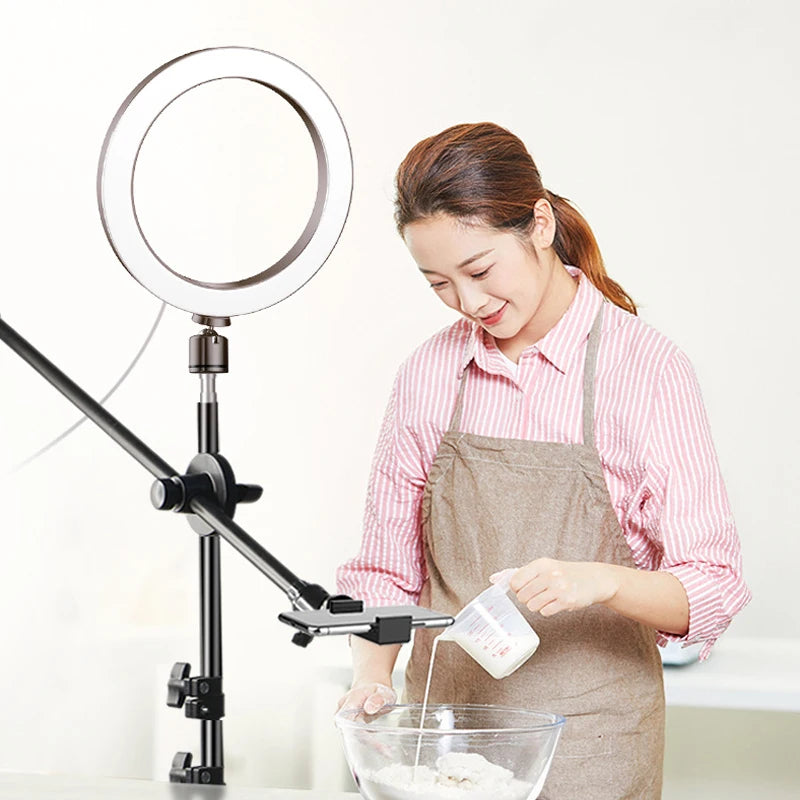 Adjustable black metal overhead phone mount and circular LED light for recording cooking or craft tutorials.