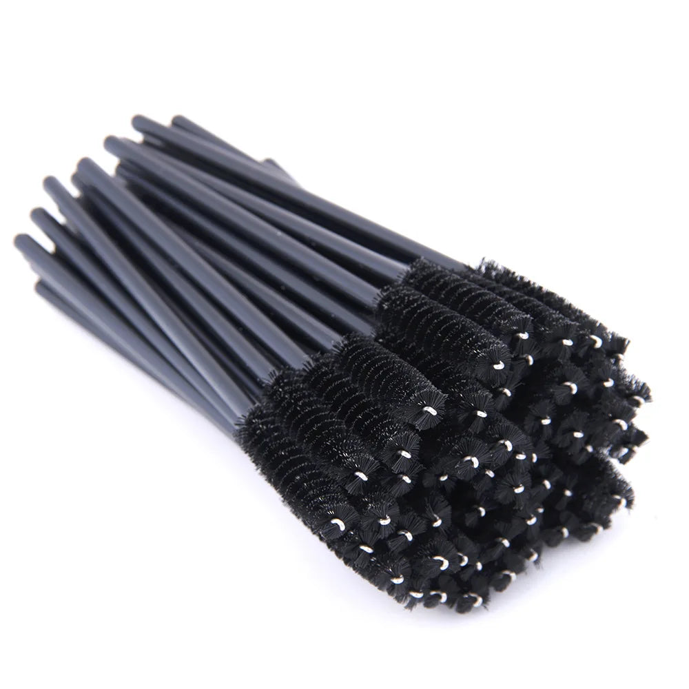Bundle of black disposable eyelash mascara brushes with plastic handles and spiral nylon bristles.