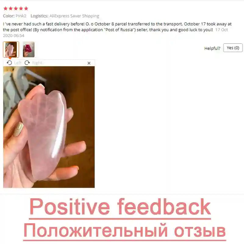 A hand holding a smooth, pink, heart-shaped rose quartz gua sha facial massage stone.