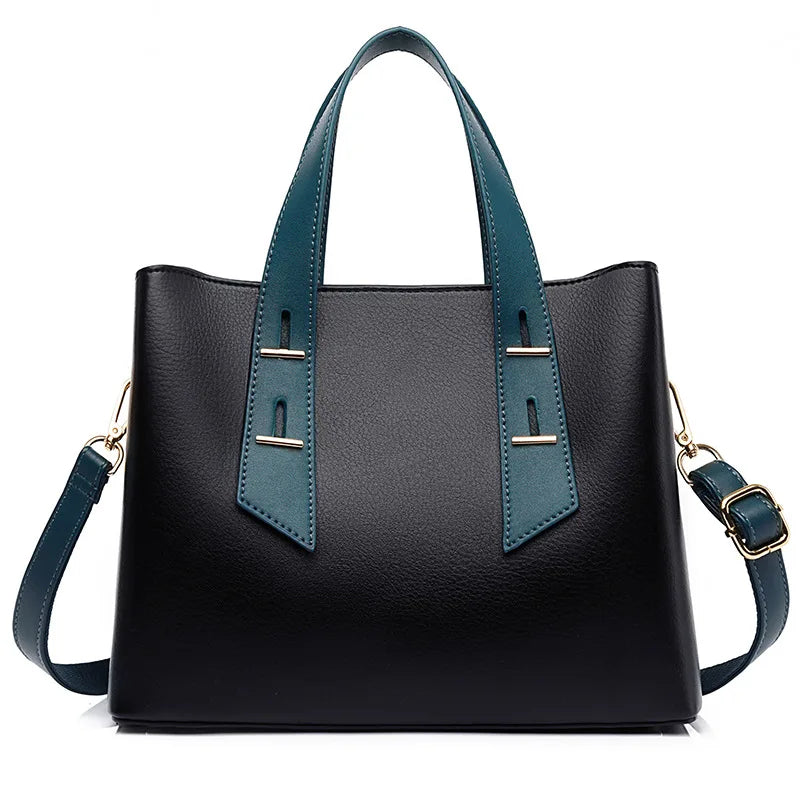 Black leather designer handbag with teal handles, gold accents, and a detachable crossbody strap.