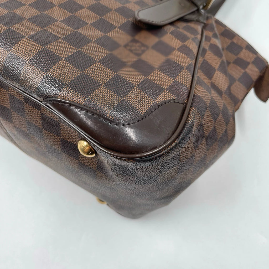 Vintage designer handbag in brown checkerboard canvas with leather trim, gold hardware, and unisex shoulder bag style.