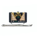 Black crystal-encrusted designer clutch bag with gold and green beaded artwork, chain strap, and "CANNAMIST" lettering.
