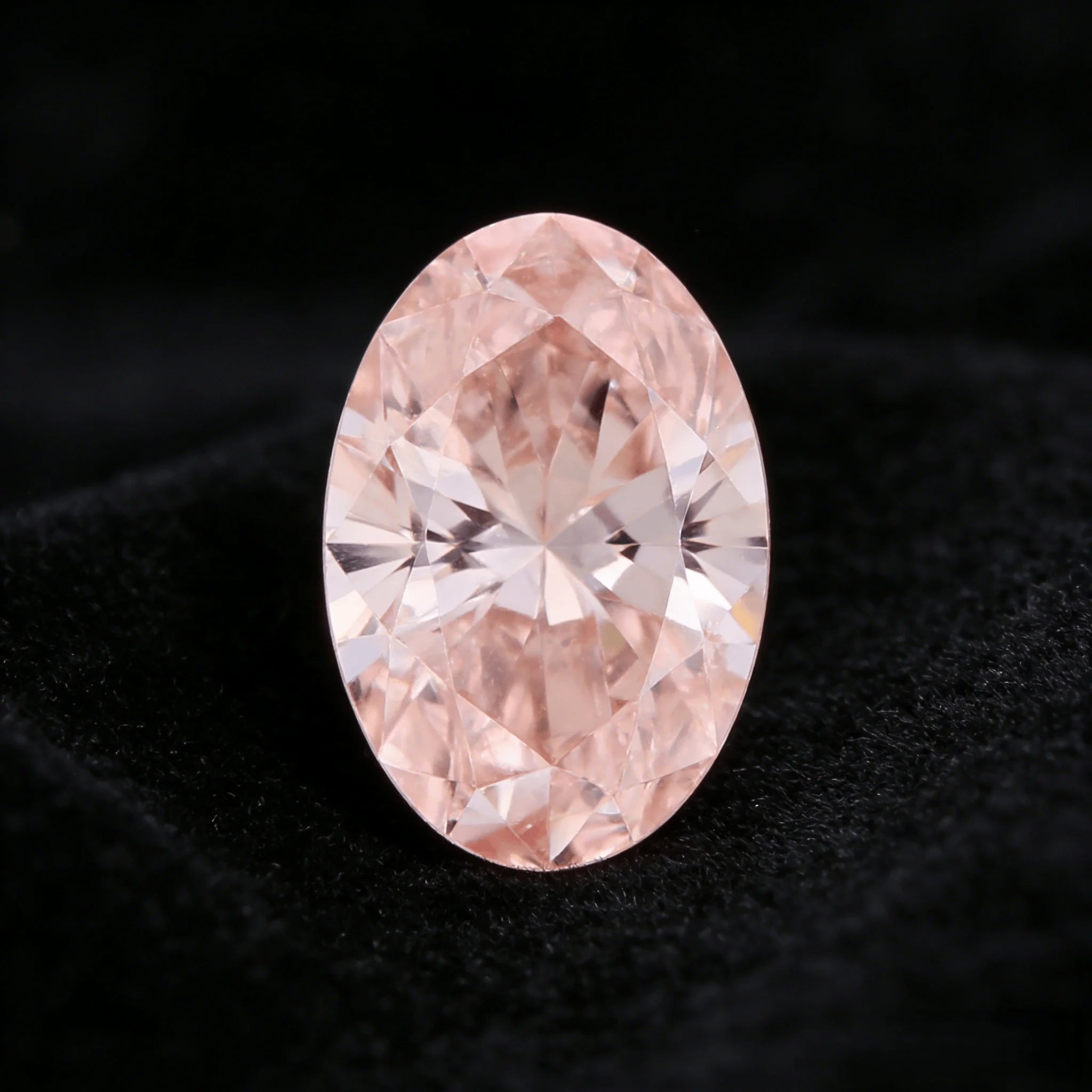 Oval fancy pink lab-grown diamond showing symmetrical facet star at center
