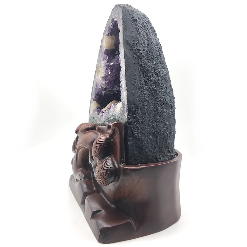 Purple amethyst geode on a carved brown holder with raised floral figures