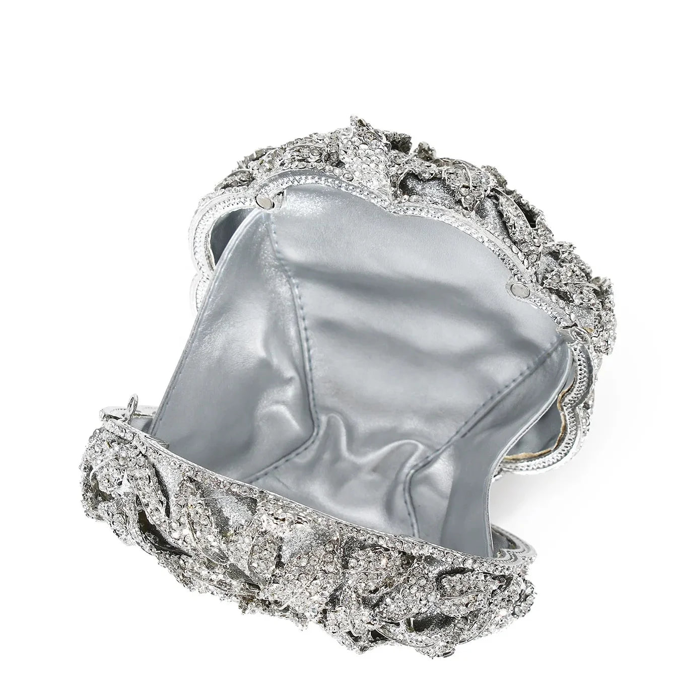 Silver designer clutch bag with rhinestone flower embellishments, perfect for weddings and evening parties.