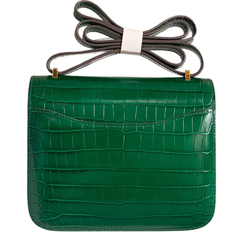 Green genuine leather compact shoulder bag with alligator pattern, gold hardware, and detachable strap. Luxury trunk style.