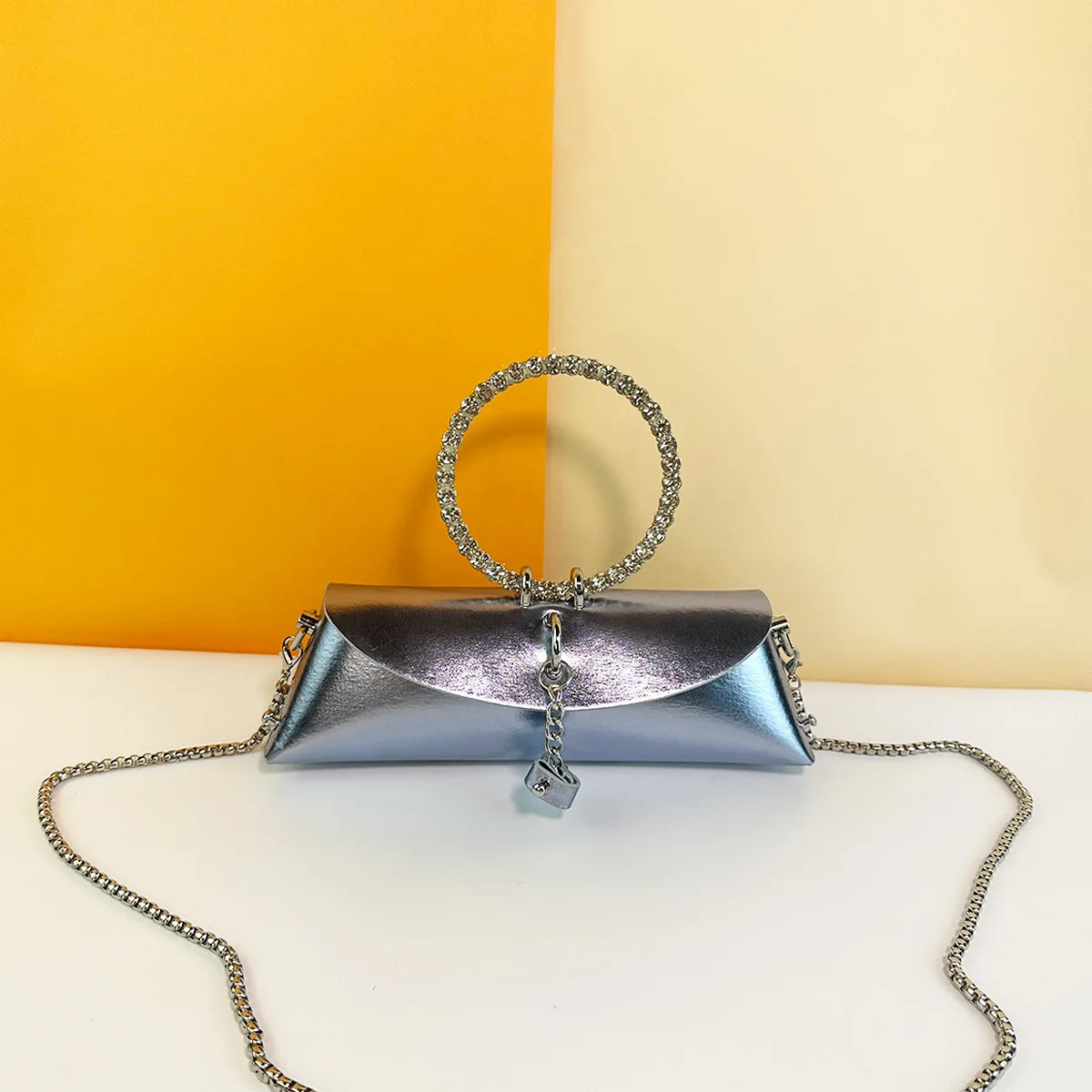 Metallic silver PU trunk clutch with rhinestone ring handle and silver chain strap for formal evening weddings.