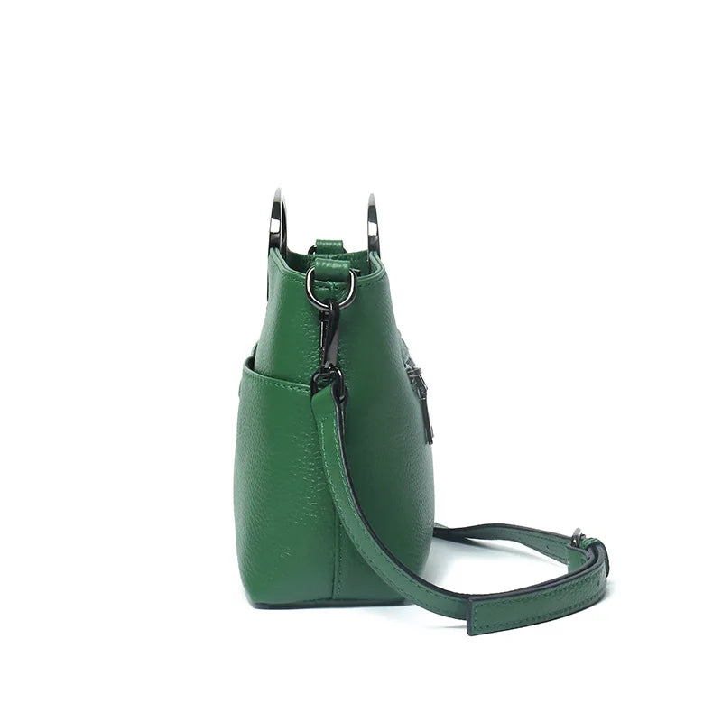 Green designer handbag with pebbled PU leather, metal handles, and detachable crossbody strap. Stylish luxury purse.