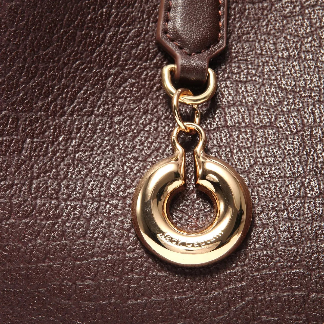 Brown alligator pattern genuine leather designer handbag with gold circular Jack Captain charm.